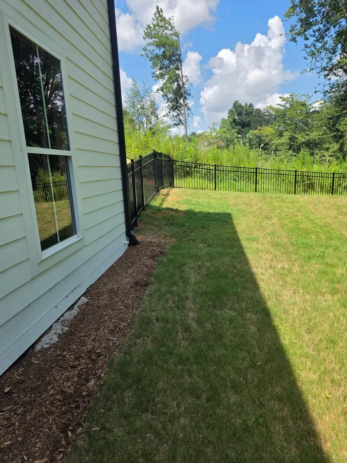 Aluminum fence line starting at the house corner