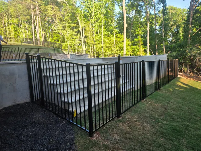 Aluminum fence and gate along a custom stone staircase