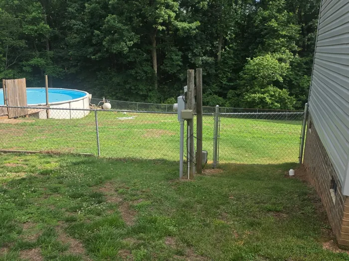 Chain-link fencing enclosing an above-ground pool