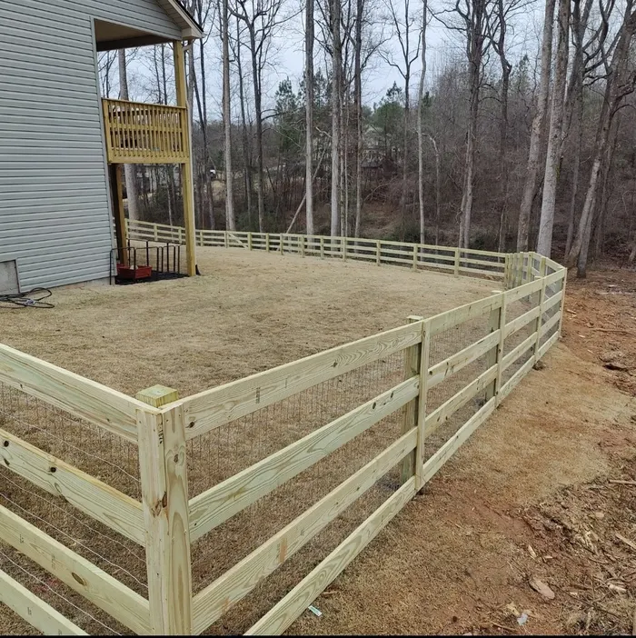 Wood rail fence stepping down a sloped backyard