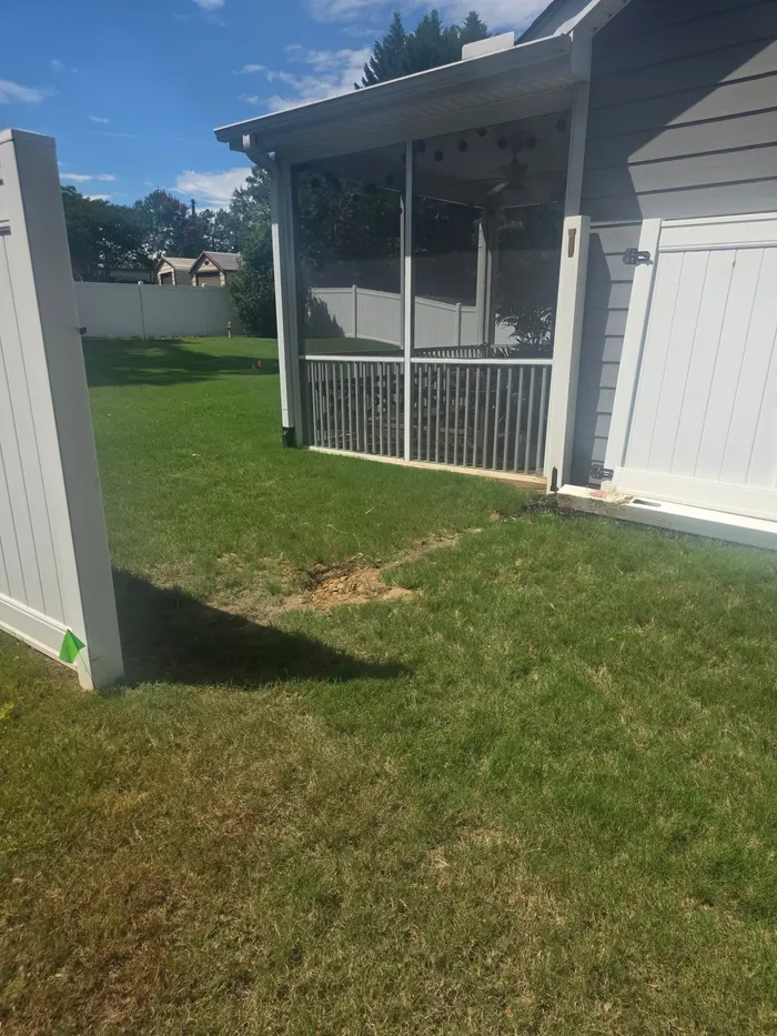 Vinyl privacy fencing turning the corner by a screened porch